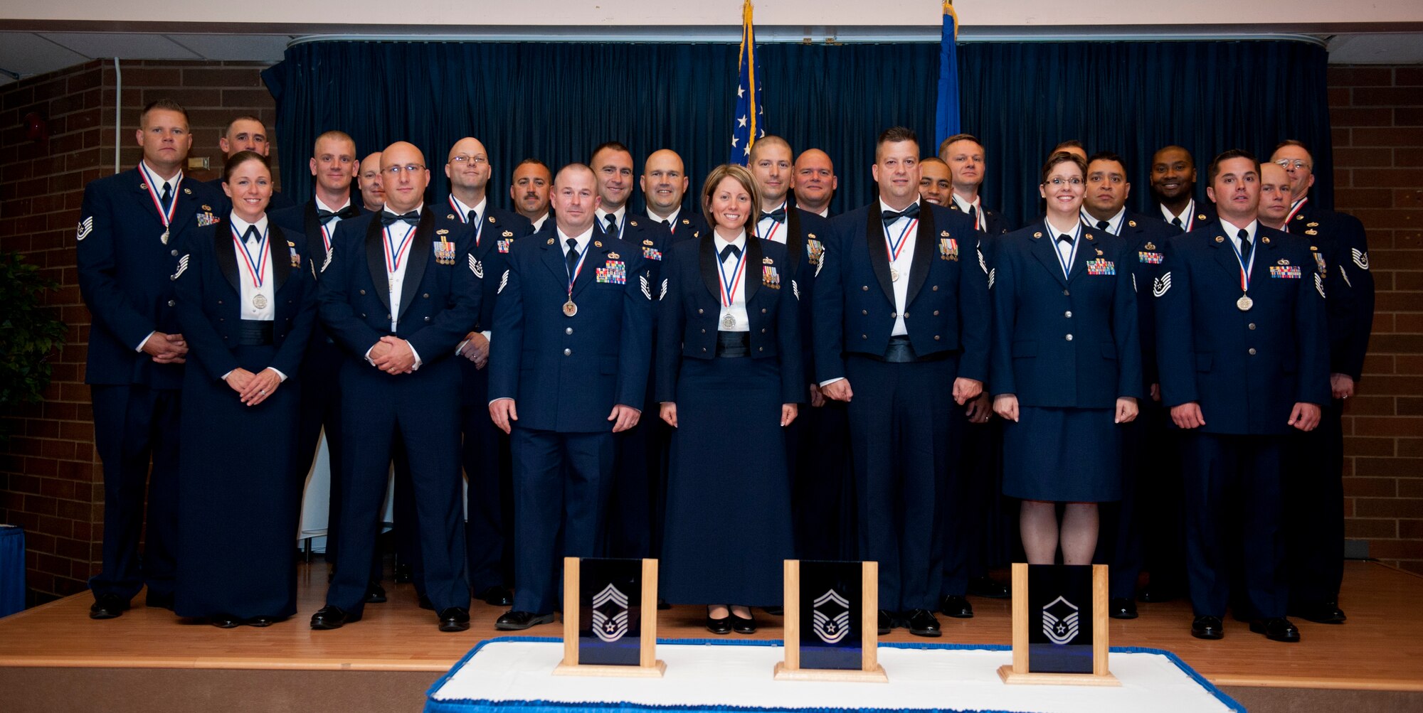 U.S. Air Force Airmen pose for a photo during the 2013 Senior NCO Induction Ceremony Aug. 22, 2013, at Mountain Home Air Force Base, Idaho. Each inductee was selected for promotion to master sergeant, signaling their entry into the Senior NCO corps. (U.S. Air Force photo by Airman 1st Class Brittany A. Chase/Released)