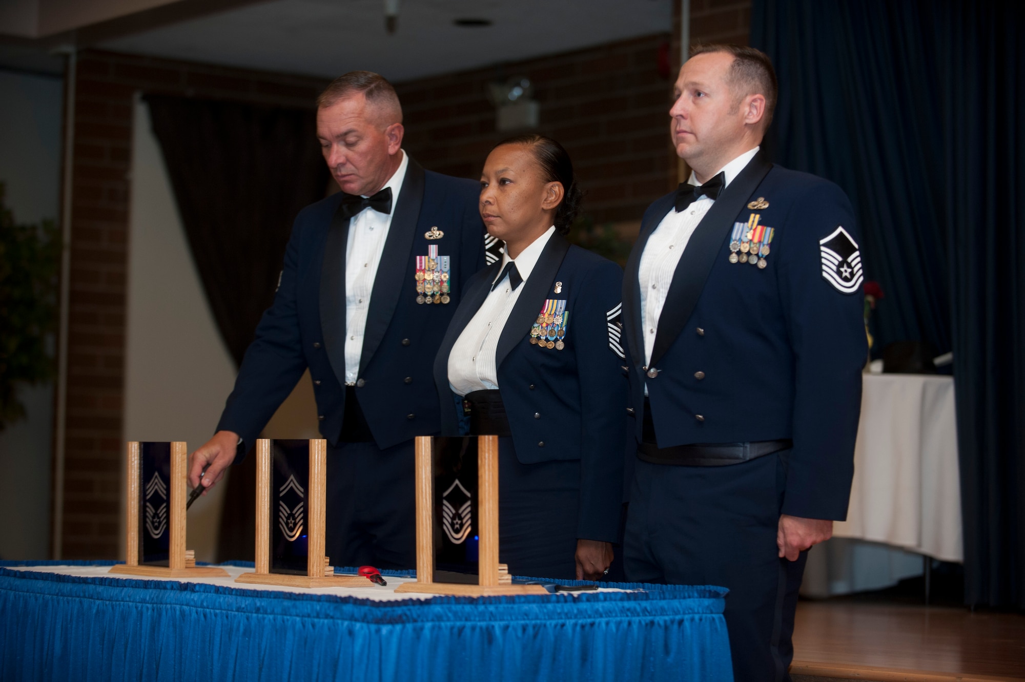 U.S. Air Force Chief Master Sgt. Paul Cornell, 366th Equipment Maintenance Squadron first sergeant, lights a candle during the 2013 Senior NCO Induction Ceremony Aug. 22, 2013, at Mountain Home Air Force Base, Idaho. Cornell lit a candle signifying the importance of his respective rank in the senior NCO tier. (U.S. Air Force photo by Airman 1st Class Brittany A. Chase/Released)