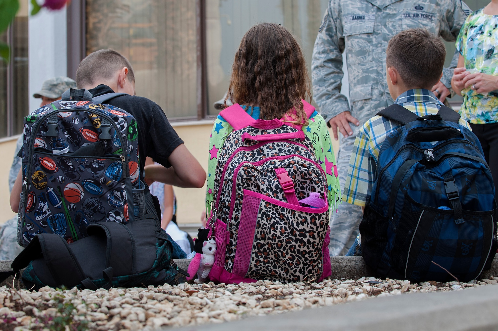 U.S. Air Force Tech. Sgt. Kelly Gamez, 39th Medical Group NCO in charge of Personnel Reliability Program and flight medicine, and Staff Sgt. Blake Gamez, 39th Logistics Readiness Squadron NCO in charge of outbound freights, walk with their daughter to her first day of school Aug. 26, 2013, Incirlik Air Base, Turkey. The first day of school is a community event at Incirlik AB, during which the wing commander welcomes the new school year with the sounding of the gong. (U.S. Air Force photo by Airman 1st Class Nicole Sikorski/Released) 