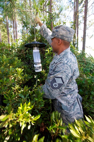 TYNDALL AIR FORCE BASE, Fla. – Master Sgt. Christopher Beach, pest management career field manager at the Air Force Civil Engineer Center, places a mosquito trap at the Silver Flag training facility here. After the mosquitoes are trapped, they are then tested to see if they are carrying any diseases such as West Nile Virus or Eastern Equine Encephalitis. (U.S. Air Force photo/Eddie Green)