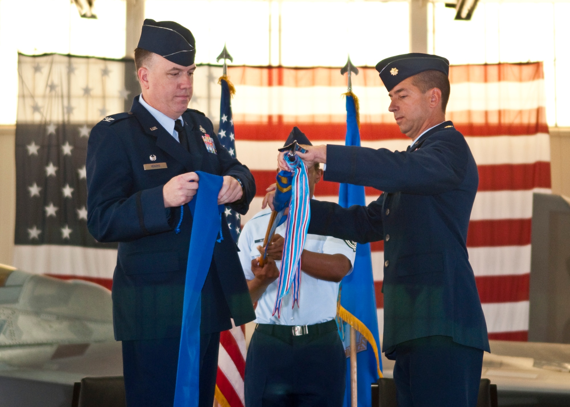 U.S. Air Force Col. Matthew Venzke, 1st Maintenance Group commander, and Maj. Paul Netchaeff, 1st Maintenance Operations Squadron commander, ceremonially case the squadron guidon during the 1st MOS inactivation ceremony at Langley Air Force Base, Va., Aug. 23, 2013. The 1st MOS was the 1st Fighter Wing's focal point for maintaining the combat readiness of its F-22 Raptor fleet and the combat readiness of 1st MXG aviators for nearly 22 years. (U.S. Air Force photo by Senior Airman Jason J. Brown/Released)