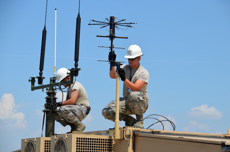 TSgt. Lui Puga and SrA. Kyle Gauthier, 439th Airlift Control Flight communications, prepare the antenna's atop the Hard-sided Expandable Lightweight Air Mobility Shelter in Pueblo, Colo., Aug. 22, just before the start of the annual AFRC-sponsored air mobility exercise, "Patriot Express." The ALCF is responsible for the training of Air Force and sister service units on how to move by air. They instruct over 400 units in preparing and loading their mobility equipment for air shipment. (U.S. Air Force photo/SrA. Kelly Galloway) 