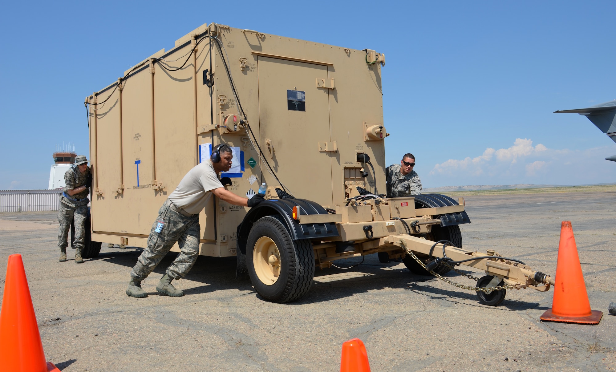 Westover's 439th Airlift Control Flight members push the Hard-sided Expandable Lightweight Air Mobility Shelter into place in Pueblo, Colorado, Aug. 22, 2013 just before the start of the annual AFRC-sponsored air mobility exercise, "Patriot Express." The ALCF is responsible for the training of Air Force and sister service units on how to move by air. They instruct over 400 units in preparing and loading their mobility equipment for air shipment. (U.S. Air Force photo/SrA. Kelly Galloway) 