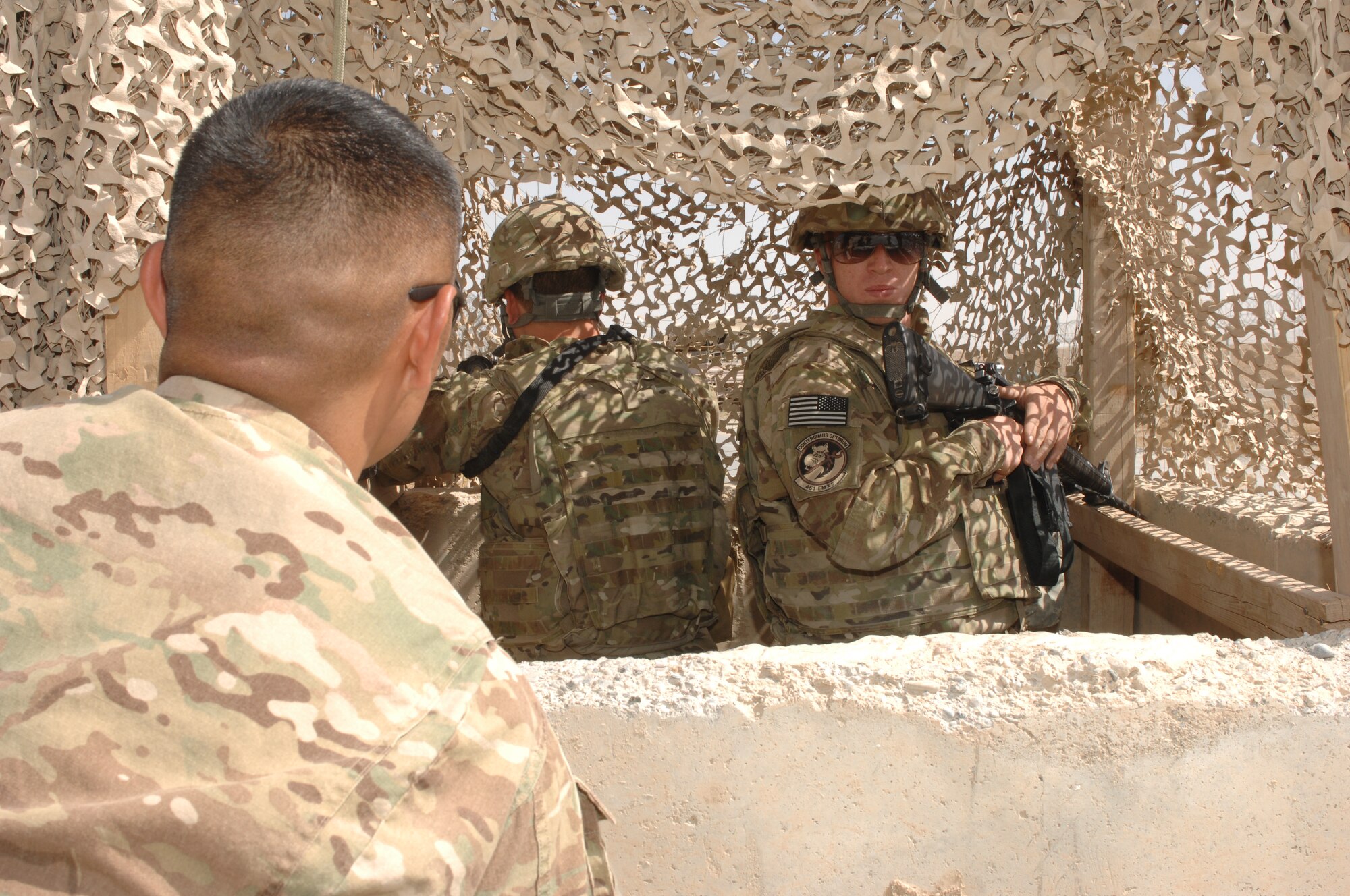 (From left) Staff Sgt. Brandon Etsitty, 451st Air Expeditionary Wing Force Protection, questions Airman 1st Class Ty Cole and Senior Airman Jacob Newton, 451st Expeditionary Maintenance Squadron Munitions Flight, during a force protection exercise at Kandahar Airfield, Afghanistan Aug. 22, 2013. The 451st AEW Anti-terrorism/Force Protection conducts exercises at each 451st AEW location throughout Afghanistan to ensure Airmen are prepared in the event of an attack. Etsitty is deployed from Lackland Air Force Base, Texas, and Cole and Newton are deployed from Spangdahlem Air Base, Germany. (U.S. Air Force photo by Senior Airman Jack Sanders)   