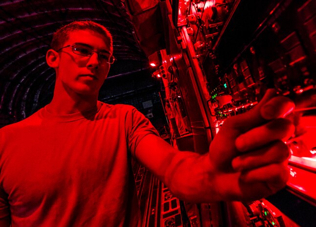 Senior Airman Cody Richman, 437th Aircraft Maintenance Squadron C-17 Globemaster III flying crew chief, checks to ensure power to the aircraft is working in the aircraft’s cargo bay Aug. 12, 2013, at Joint Base Charleston – Air Base, S.C. The cargo bay can be lit with florescent, red or green lights depending on the mission. (U.S. Air Force photo/ Senior Airman Dennis Sloan)