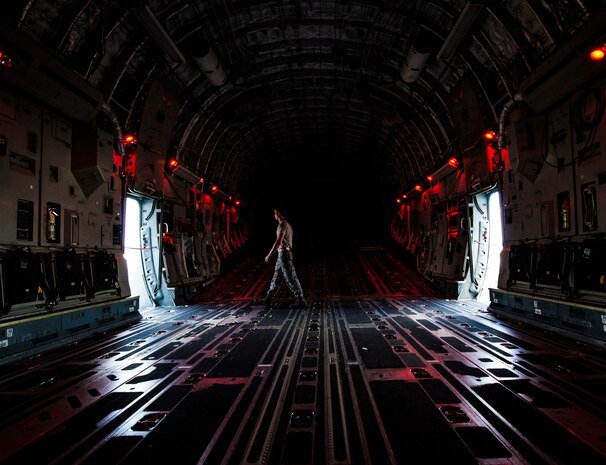 Senior Airman Cody Richman, 437th Aircraft Maintenance Squadron C-17 Globemaster III flying crew chief, opens the rear doors on a C-17 to allow light into the cargo bay Aug. 12, 2013, at Joint Base Charleston – Air Base, S.C. (U.S. Air Force photo/ Senior Airman Dennis Sloan)