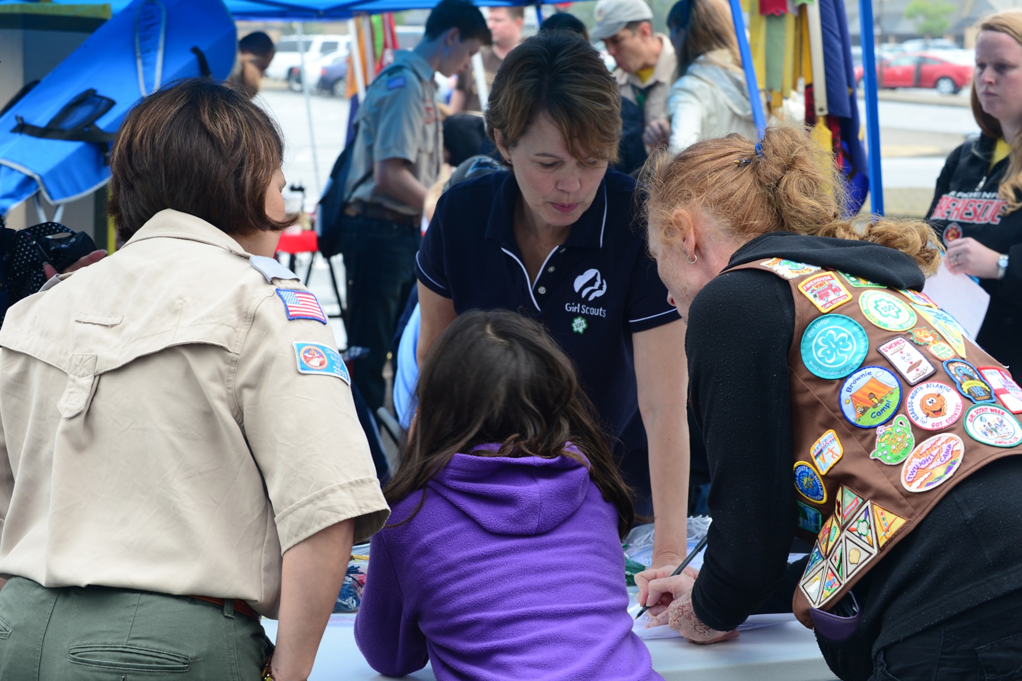Children sign up for Girl, Boy or Cub Scouts at a scouting recruitment fair at Royal Air Force Lakenheath, England, Aug. 24, 2013. The scouting recruitment fair was held at RAF Lakenheath, for boys, girls and prospective volunteers interested in joining the scouts. (U.S. Air Force photo by Airman 1st Class Dana J. Butler/Released)