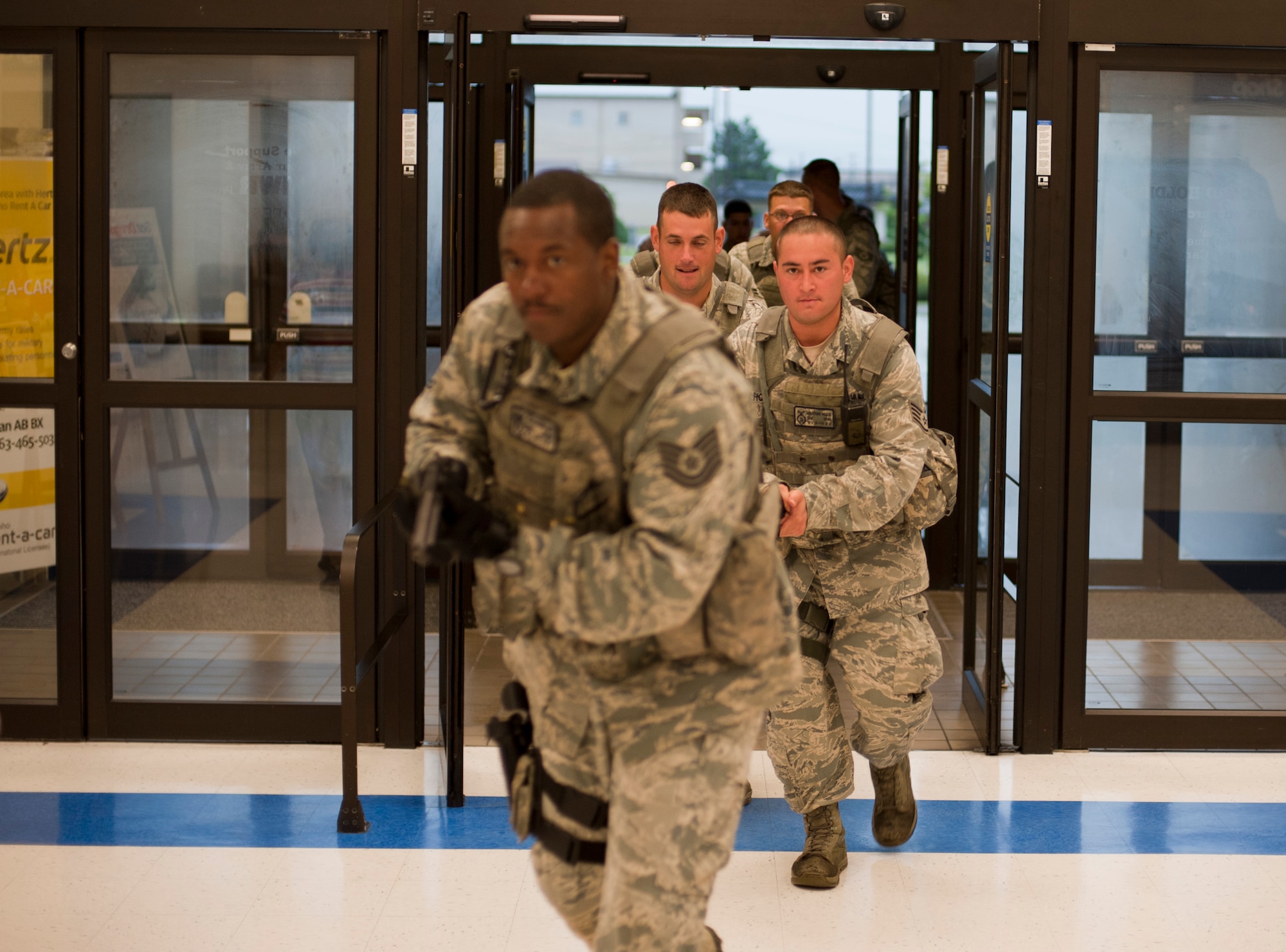 KUNSAN AIR BASE, Republic of Korea -- Airmen from the 8th Security Forces squadron flood into the Base Exchange during a training exercise Aug. 23, 2013. The Airmen responded to several scenarios designed to tests skills they had learned during the Pacific Air Forces High Risk Response Training course. (U.S. Air Force photo by Senior Airman Armando A. Schwier-Morales/ Released)