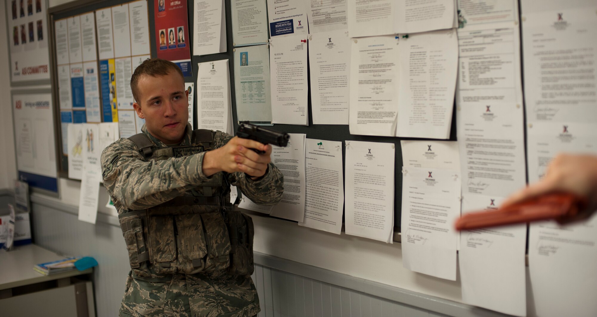 KUNSAN AIR BASE, Republic of Korea -- Airman 1st Class Cody Moses, 8th Security Forces response team member, engages an active shooter Aug 23, 2013. Instructors from Asymmetric Threat, a division of Analytical Services Incorporated, tested Moses and fellow Airmen with sensory overload to examine their performance under pressure during the Pacific Air Forces High Risk Response Training. (U.S. Air Force photo by Senior Airman Armando A. Schwier-Morales/ Released)