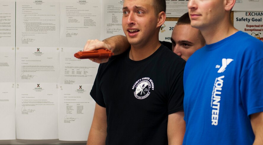 KUNSAN AIR BASE, Republic of Korea -- An active shooter role player hides behind his hostage role players as security forces personnel enter the area Aug. 23, 2013. Role players helped to test the 8th Security Forces Squadron newly learned skills taught during a five day course.(U.S. Air Force photo by Senior Airman Armando A. Schwier-Morales/ Released)