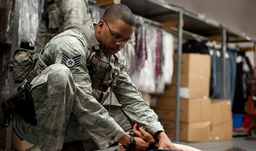 KUNSAN AIR BASE, Republic of Korea -- Staff Sgt. Michael Brice, 8th Security Forces NCOIC of Police Services, handcuffs a suspect during a training scenario Aug. 23, 2013. 8th SFS Airmen trained for a week to hone their active-shooter response skills. (U.S. Air Force photo by Senior Airman Armando A. Schwier-Morales/ Released)