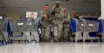 KUNSAN AIR BASE, Republic of Korea -- Airmen from the 8th Security Forces squadron flood into the Exchange during a training exercise Aug. 23, 2013. The Airmen responded to several scenarios designed to tests skills they had learned during the Pacific Air Forces High Risk Response Training course. (U.S. Air Force photo by Senior Airman Armando A. Schwier-Morales/ Released)