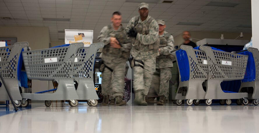 KUNSAN AIR BASE, Republic of Korea -- Airmen from the 8th Security Forces squadron flood into the Exchange during a training exercise Aug. 23, 2013. The Airmen responded to several scenarios designed to tests skills they had learned during the Pacific Air Forces High Risk Response Training course. (U.S. Air Force photo by Senior Airman Armando A. Schwier-Morales/ Released)