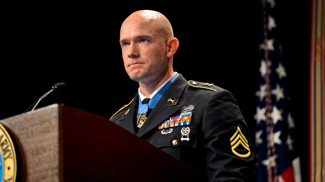 Medal of Honor recipient Army Staff Sgt. Ty Michael Carter holds back tears as he tells his story during a ceremony in his honor at the Pentagon, Aug. 27, 2013.