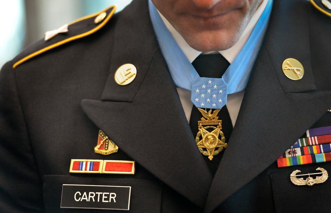 Army Staff Sgt. Ty Michael Carter wears the Medal of Honor around his neck during a ceremony to honor him at the Pentagon, Aug. 27, 2013.