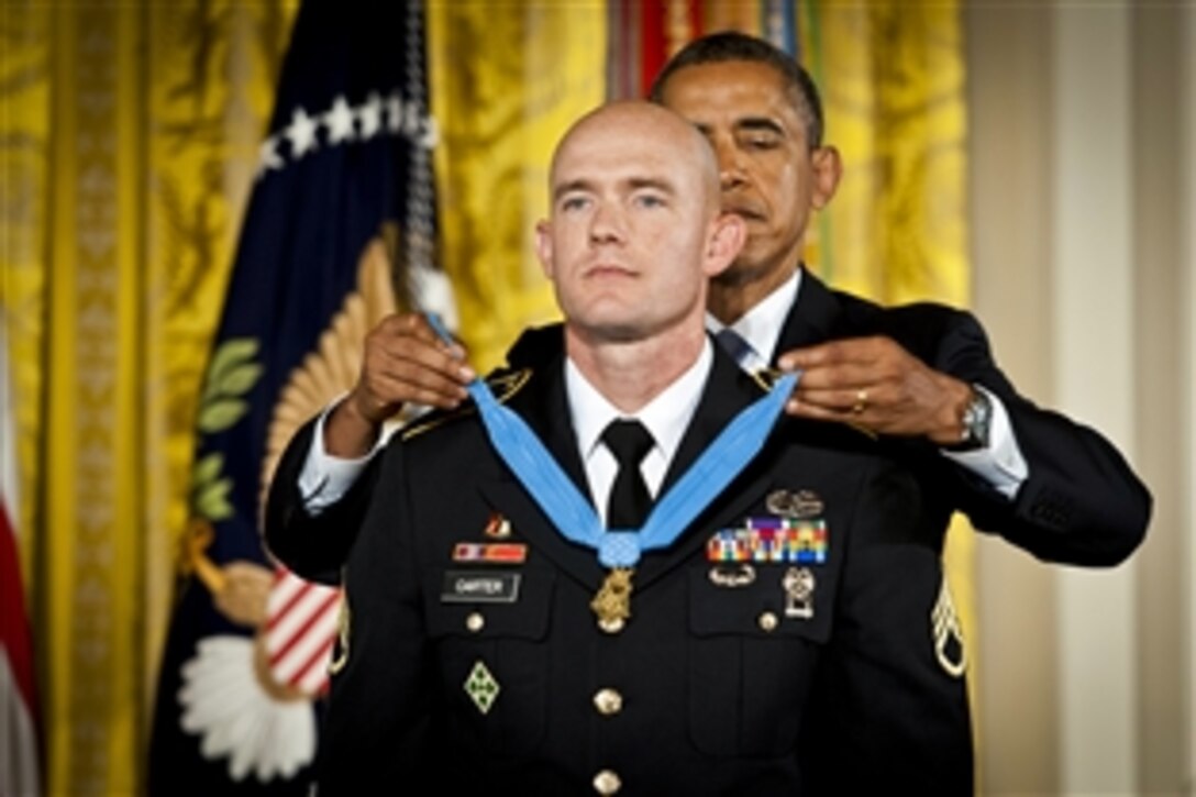 President Barack Obama presents Army Staff Sgt. Ty Michael Carter with the Medal of Honor at the White House, Aug. 26, 2013. Carter, a scout, risked his life during combat operations against an armed enemy in Afghanistan's Nuristan province, Oct. 3, 2009. 