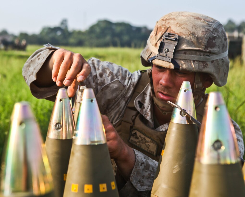 Cpl. Griffith D. Moore puts fuses on M777A2 155 mm lightweight howitzer rounds Aug. 21 at the Rodriguez Live-Fire Complex during Korean Marine Exchange Program 13-8. Throughout the exercise, Republic of Korea and U.S. Marines conducted live-fire training, helicopter operations, and military operations in urban terrain training as well as cultural exchanges and tours of the country. Moore is an artilleryman with Battery I, 3rd Battalion, 11th Marine Regiment, currently assigned to 12th Marine Regiment, 3rd Marine Division, III Marine Expeditionary Force under the unit deployment program. (U.S. Marine Corps photo by Lance Cpl. Kasey Peacock/Released)