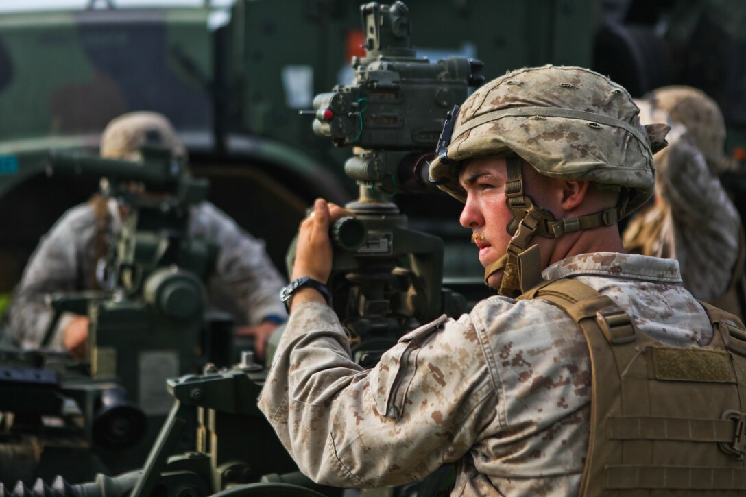 Lance Cpl. Jacob V. Kaufman prepares to sight in an M777A2 155 mm lightweight howitzer for direct fire at the Rodriguez Live-Fire Complex Aug. 21 as part of Korean Marine Exchange Program 13-8. Throughout the exercise, Republic of Korea and U.S. Marines conducted live-fire training, helicopter operations, and military operations on urban terrain training as well as cultural exchanges and tours of the country. Kaufman is an artilleryman with Battery I, 3rd Battalion, 11th Marine Regiment, currently assigned to 12th Marine Regiment, 3rd Marine Division, III Marine Expeditionary Force under the unit deployment program.