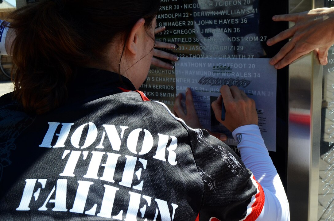 Jennifer Marino, a retired major, is cycling more than 2,700 miles, through 17 states, over the span of 77 days to meet with American Gold Star Mothers and their families in commemoration of service members killed in combat. One of Marino’s stops is the Northwood Gratitude and Honor Memorial in Irvine, Calif. where she gathered rubbings of the names of several service members. She plans to hand deliver the names to some of the families she will visit as she crosses the country.
