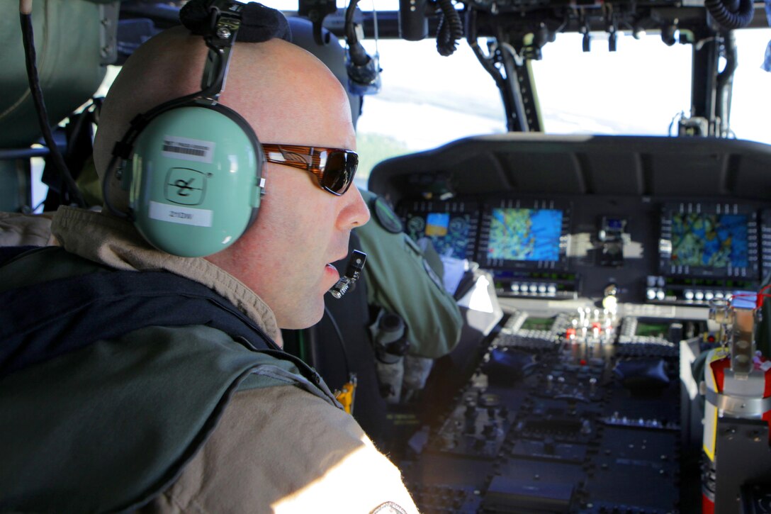 During a Forward Air Controller (Airborne) and Close Air Support rehearsal of concepts with Swedish Air Force aviators, Capt. Thomas J. Duff, a FAC(A) subject matter expert and AH-1W Cobra instructor pilot, calls in for the time-on-station while flying in a SwAF UH-60 Black Hawk helicopter. Marine aviation instructors from Marine Air Weapons and Tactics Squadron One, Yuma, Ariz., introduced Forward Air Controller (Airborne) and Close Air Support concepts, tactics, and procedures for evaluation into the Swedish Air Force’s aviation training with SwAF pilots from the 21st UH-60 Black Hawk Helicopter Wing and the JAS-39 Gripen Operations, Tactics and Evaluations division, August 5-23 at Malmen Military Base, Linköping, Sweden.

