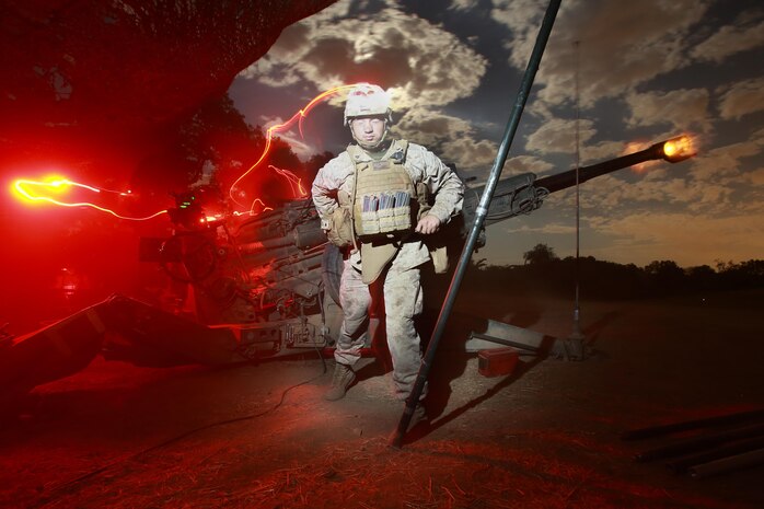 Corporal Taylor Welcome, field artillery cannoneer, Kilo Battery, 2nd Battalion, 11th Marine Regiment, fires an M777 Lightweight Howitzer during the 11th Marines fire exercise here, Aug. 22, 2013. Eleventh Marines, an artillery regiment comprised of four battalions, demonstrated their ability to shoot, move and communicate to support of 1st Marine Division during a large-scale, live-fire training exercise, Aug. 19 through 28. Welcome is a native of St. George, Utah.