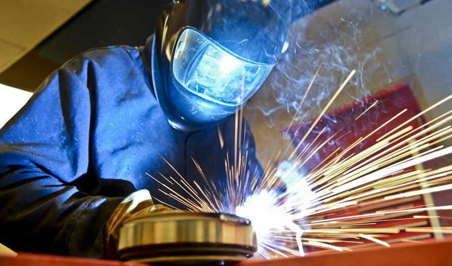 Staff Sgt. Alex Aguayo welds together a rotational plate he designed for a paint work station, Aug 22, 2013 at MacDill Air Force Base, Fla. Aguayo is one of two Airmen who co-engineered a way to centrifugally mount a KC-135 Stratotanker's nose and main landing wheel on a rotating base, which reduces a wheel’s paint process by 50 percent. Aguayo is an aircraft metals technician with the 6th Maintenance Squadron. (U.S. Air Force photo/Staff Sgt. Brandon Shapiro)