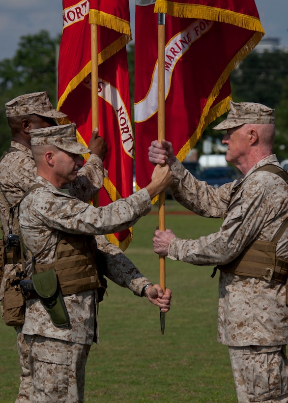 Sgt.Maj. Anthony A. Spadaro, the sergeant major of Marine Forces Reserve and Marine Forces North, passes the organizational colors to Lt. Gen. Richard P. Mills, the commander of MARFORRES and MARFORNORTH, during the MARFORRES assumption of command and appointment ceremony aboard Marine Corps Support Facility New Orleans, Aug. 28, 2013. Mills is taking charge of the largest command in the Marine Corps, encompassing more than 100,000 Marines at more than 160 sites in 47 U.S. states, Guam and Puerto Rico.