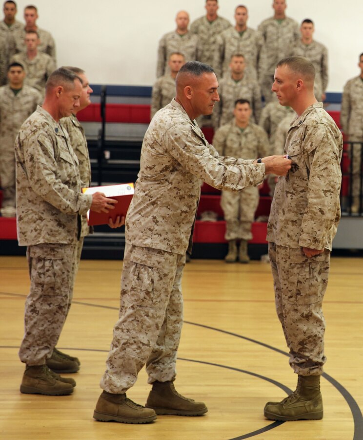 – Brigadier Gen. James Lukeman, commanding general of 2nd Marine Division, pins the Silver Star onto Sgt. Ryan Steinkamp’s chest during his award ceremony aboard Marine Corps Base Camp Lejeune, Aug. 28, 2013. Steinkamp earned the Silver Star for leading his squad through a hostile village and engaging the enemy while deployed to Afghanistan in support of Operation Enduring Freedom in 2012. 