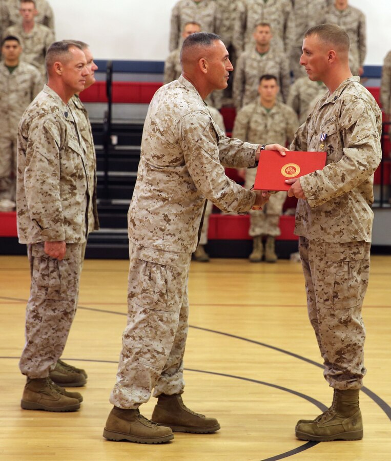 Brigadier Gen. James Lukeman, commanding general of 2nd Marine Division, shakes hands with Sgt. Ryan Steinkamp, an infantryman with 1st Battalion, 8th Marine Regiment, 2nd Marine Division during his award ceremony aboard Marine Corps Base Camp Lejeune, Aug. 28, 2013. Steinkamp earned the Silver Star for leading his squad through a hostile village and engaging the enemy while deployed to Afghanistan in support of Operation Enduring Freedom in 2012.