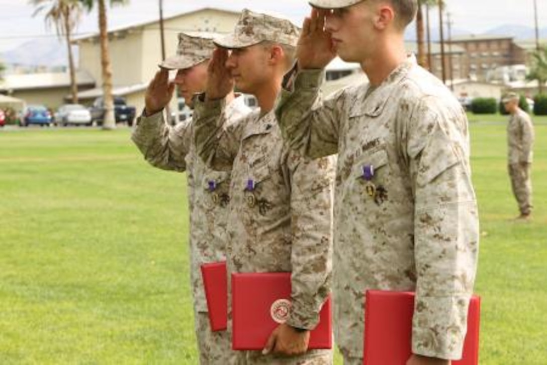 Lance Cpl. Colin Schafer, Lance Cpl. Phillip Cutler and Cpl. Samuel Robertson, infantrymen, 2nd Battalion, 7th Marine Regiment, were awarded with Purple Hearts at Lance Cpl. Torrey L. Gray Field Aug 26, 2013. The Marines earned the medals for their actions while deployed to Afghanistan in support of Operation Enduring Freedom. Robertson’s mine resistant, ambush-protected vehicle was hit by an 80-pound improvised explosive device Feb. 2. Cutler and Schafer were also hit by I.E.D’s while riding in an MRAP March 24. “The Purple Heart was established by Gen. George Washington and is a very respected medal,” Smith said. “We have a lot of good Marines in this unit and we will continue to do what we are trained to do.”


