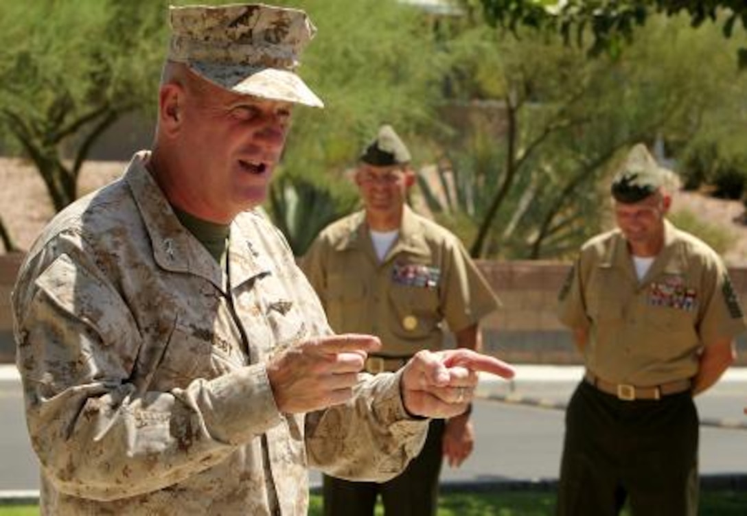 Maj. Gen. Steven W. Busby, commanding general, 3rd Marine Aircraft Wing, speaks to Cpl. Kyle Wells, motor transportation operator, 3rd Battalion, 7th Marine Regiment, and Cpl. Nathaniel Navarro, mortarman, Weapons Company, 2nd Battalion, 7th Marine Regiment, and fellow Combat Center Marines about their heroic efforts in potentially saving the life of fellow Combat Center Marine.


