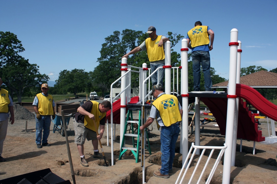 Volunteers work to assemble a playground at Black Butte Lake, April 16, 2013.
