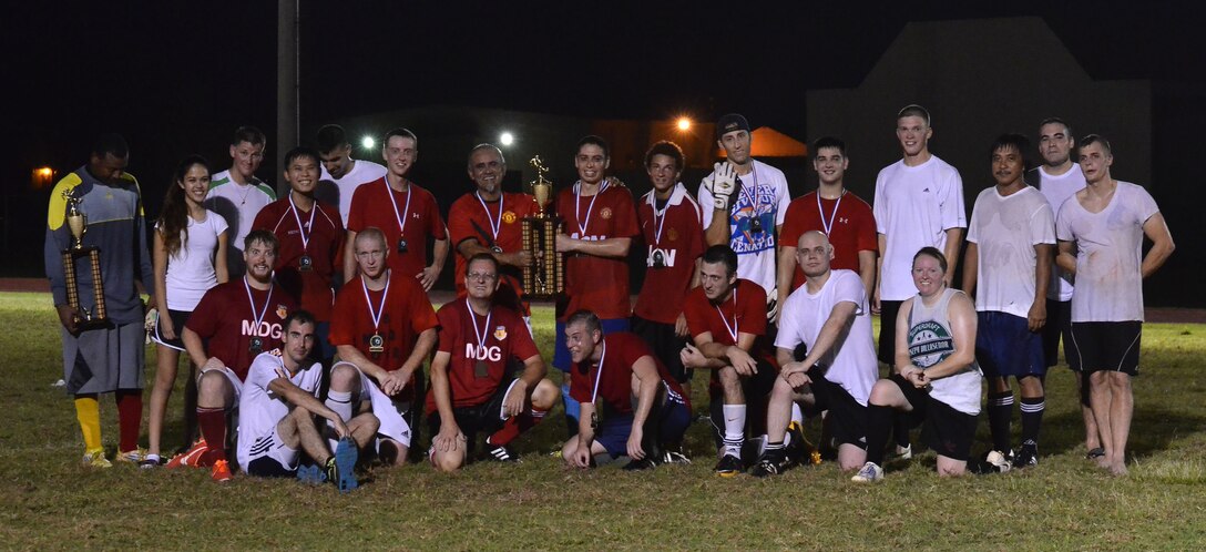 The 36th Medical Group and 36th Civil Engineer Squadron intramural soccer teams pose for a post-game photo after the intramural soccer championship game at Andersen Air Force Base, Guam, Aug. 26, 2013. The 36th MDG team won the game 2-1 and became this year’s soccer champions, finishing the season with an 8:8 win-loss record. As soccer comes to a close, the next intramural season to begin on Andersen will be flag football. The season is tentatively scheduled to start in September. (U.S. Air Force photo by Airman 1st Class Mariah Haddenham/Released)