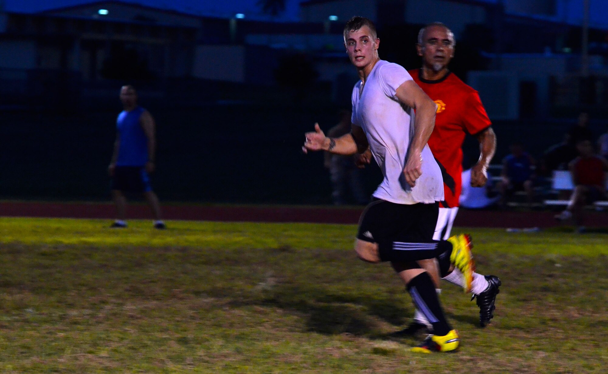 Senior Airman Reid Martinak, 36th Civil Engineer Squadron, runs past a defender from the 36th Medical Group during the intramural soccer championship game on Andersen Air Force Base, Guam, Aug. 26, 2013. The 36th MDG won the game 2-1 and became this year’s soccer champions, finishing the season with an 8:0 win-loss record. (U.S. Air Force photo by Airman 1st Class Mariah Haddenham/Released)