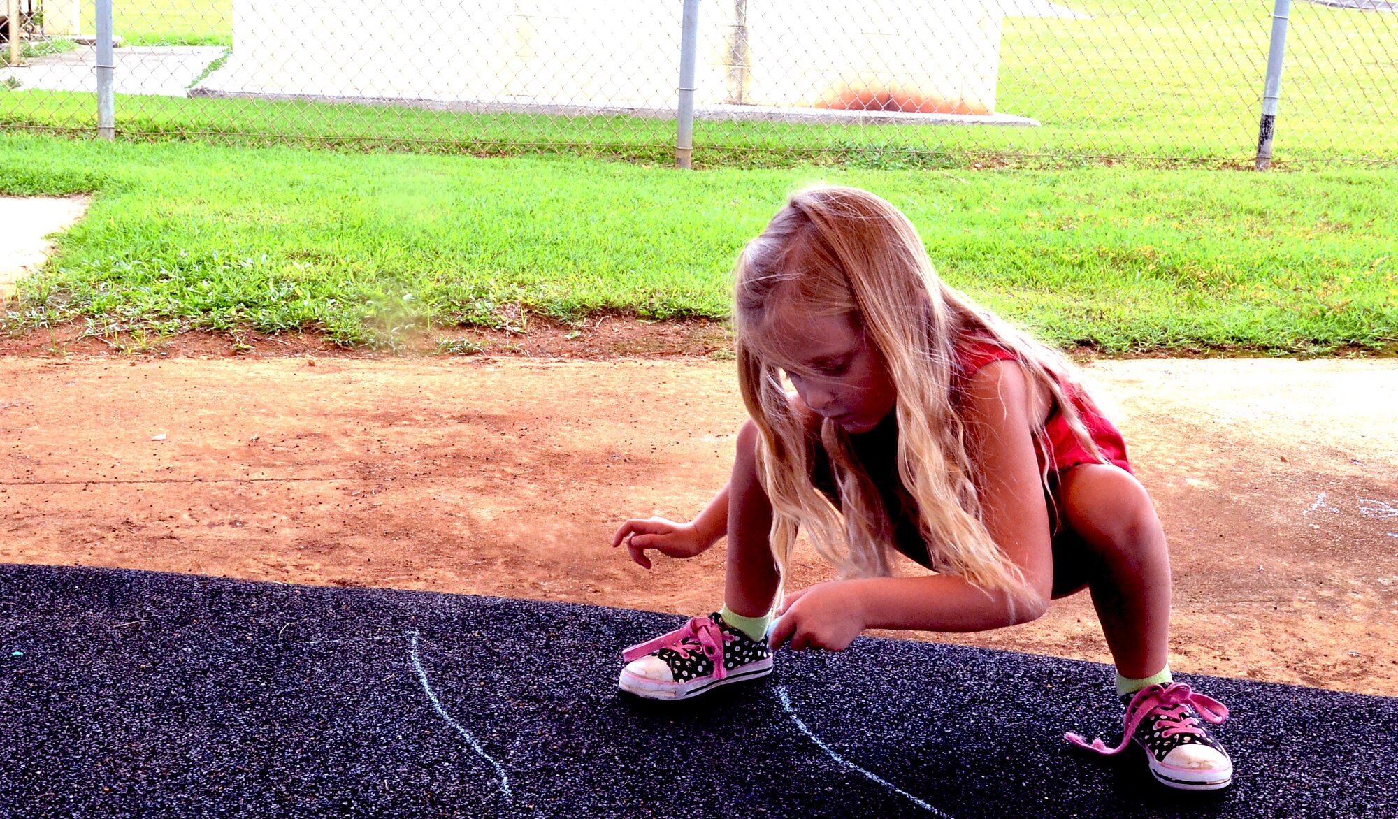 A child uses chalk during an after-school program at the Child Development Center on Andersen Air Force Base, Guam, Aug. 28, 2013. The Andersen CDC offers after-school programs that are designed to improve social skills and provide creative outlets for children ages five to 12 years old. (U.S. Air Force photo by Airman 1st Class Mariah Haddenham/Released)