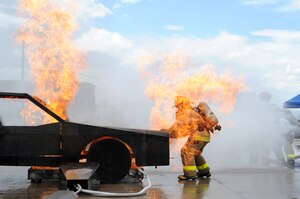 Senior Airman Christopher Crusius, a 612th Air Base Squadron firefighter, is engulfed in flames as he opens the hood during a car fire here as part of Central America Sharing Mutual Operational Knowledge and Experiences (CENTAM Smoke) Exercise Aug 27, 2013. JTF-Bravo firefighters will train alongside Hondurans, Belizeans, Costa Ricans, Guatemalans, El Salvadorans, Panamanians and Nicaraguans partner nation firefighters allowing the U.S. and Central America firefighters four days of team-building exercises.(Photograph released by U.S. Air Force Staff Sgt. Jarrod Chavana)