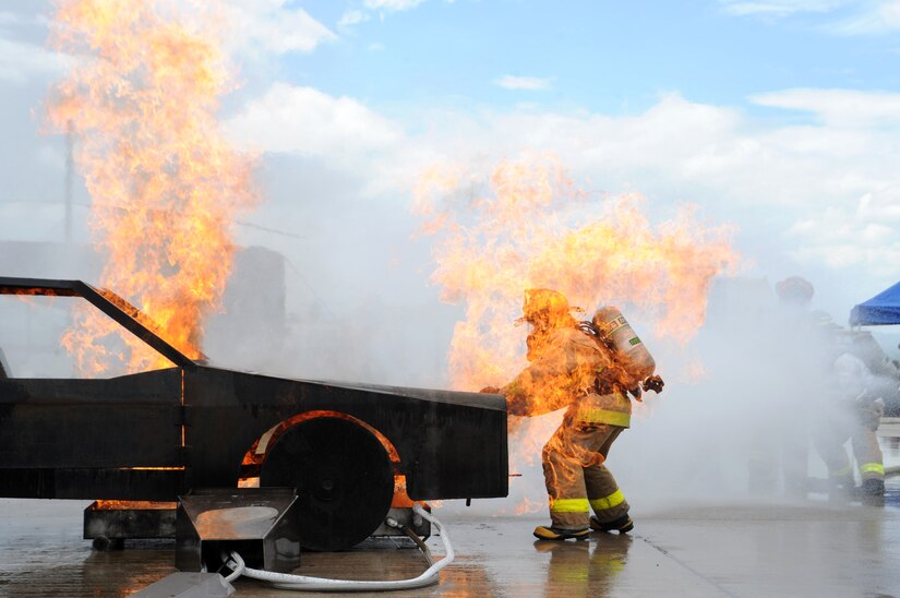 Senior Airman Christopher Crusius, a 612th Air Base Squadron firefighter, is engulfed in flames as he opens the hood during a car fire here as part of Central America Sharing Mutual Operational Knowledge and Experiences (CENTAM Smoke) Exercise Aug 27, 2013. JTF-Bravo firefighters will train alongside Hondurans, Belizeans, Costa Ricans, Guatemalans, El Salvadorans, Panamanians and Nicaraguans partner nation firefighters allowing the U.S. and Central America firefighters four days of team-building exercises.(Photograph released by U.S. Air Force Staff Sgt. Jarrod Chavana)
