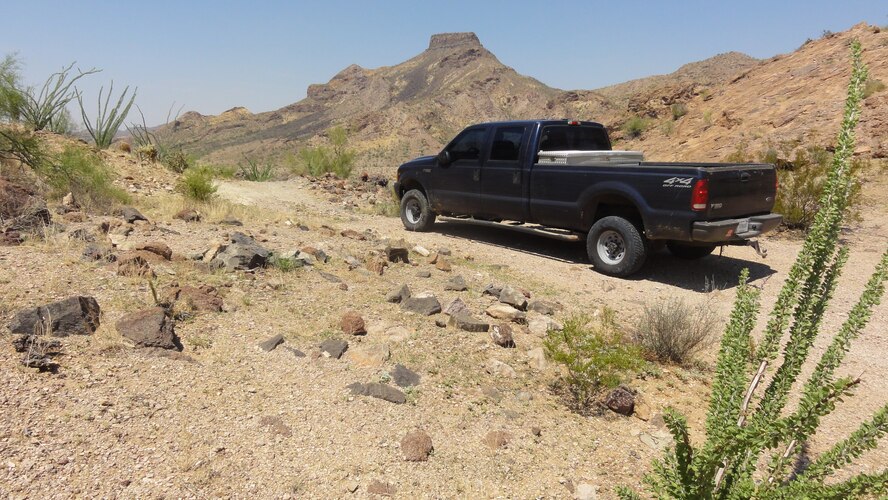 A 56th Range Management Office vehicle prepares to descend a steep grade south of Hat Mountain at the Area B Public Use Area of the Barry M. Goldwater Range in southwestern Arizona on 27 August 2013.