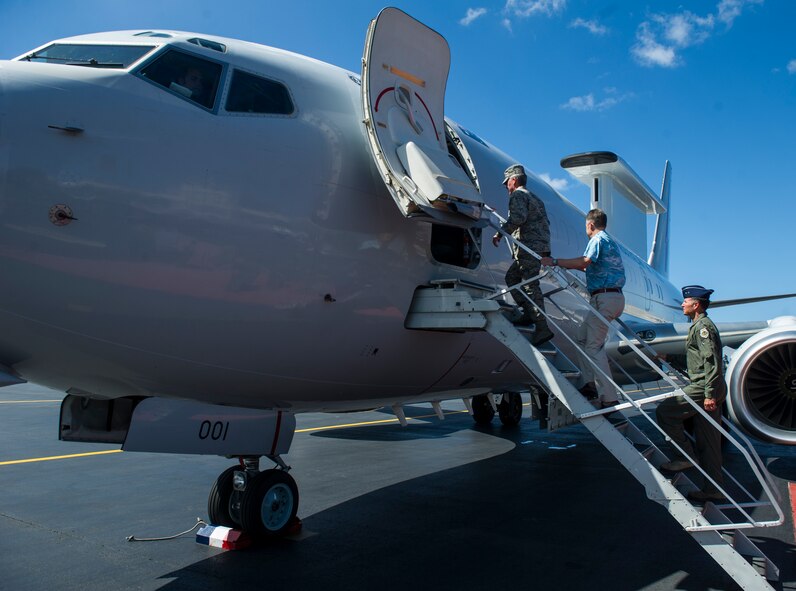 (From left) General Hawk Carlisle, Pacific Air Forces commander; Mr. Scott Dewar, Australian Consul-General in Honolulu, Hawaii; and Maj. Gen. Kevin Pottinger, PACAF Chief of Operations, climb aboard a Royal Australian Air Force E-7A Wedgetail Airborne Early Warning & Control aircraft on the flightline at Joint Base Pearl Harbor-Hickam, Hawaii, August 26, 2013.  The RAAF Wedgetail and crew were at JBPH-H on a stopover on the return home from participating in Red Flag-Alaska. AEW&C aircraft can control the tactical battle space, providing direction for fighter aircraft, surface combatants and land based elements, as well as supporting aircraft such as tankers and intelligence platforms. RAAF Wedgetail crew provided static displays and a familiarization flight to JBPH-H personnel, to familiarize Airmen with RAAF Wedgetail capabilities. (U.S. Air Force photo/Staff Sgt. Nathan Allen)