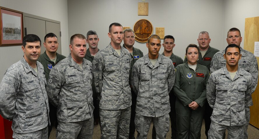 Col. Andrew Gebara, front left, 2nd Bomb Wing commander, poses for a photo with aircrew from the 96th Bomb Squadron and Airmen from the 2nd Aircraft Maintenance Squadron on Barksdale Air Force Base, La., Aug. 28, 2013. On Aug. 27, 2013 a B-52H Stratofortress was taxiing on the flightline when a fire broke out around the #3 brake. The maintenance Airmen responded to the fire and worked quickly to evacuate the aircraft and control the fire.  Staff Sgts. Billy Campbell, Martavius Davis,  Mark Corral, Airman 1st Class  Elias Delarosa and Master Sgt. Kevin Rowe were recognized by Gebara for their heroic actions. (U.S. Air Force photo/Senior Airman Micaiah Anthony)