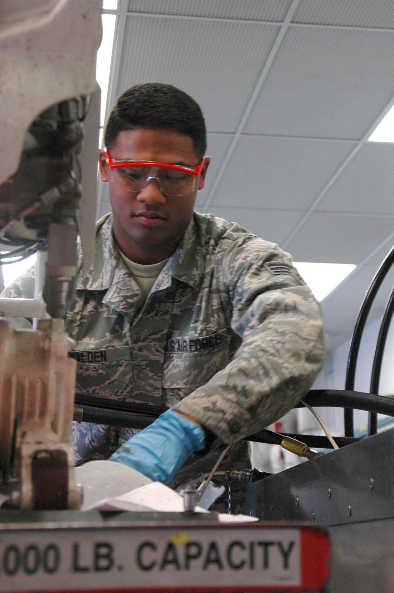 Senior Airman Joshua Walden, 446th Maintenance Squadron, prepares a C-17 winch for a hydraulics inspection Aug. 27.  Walden is one of the new crop of hydraulics specialists in the 446th MXS going through the seasoning training program. (U.S. AIr Force Reserve photo by Sandra Pishner)