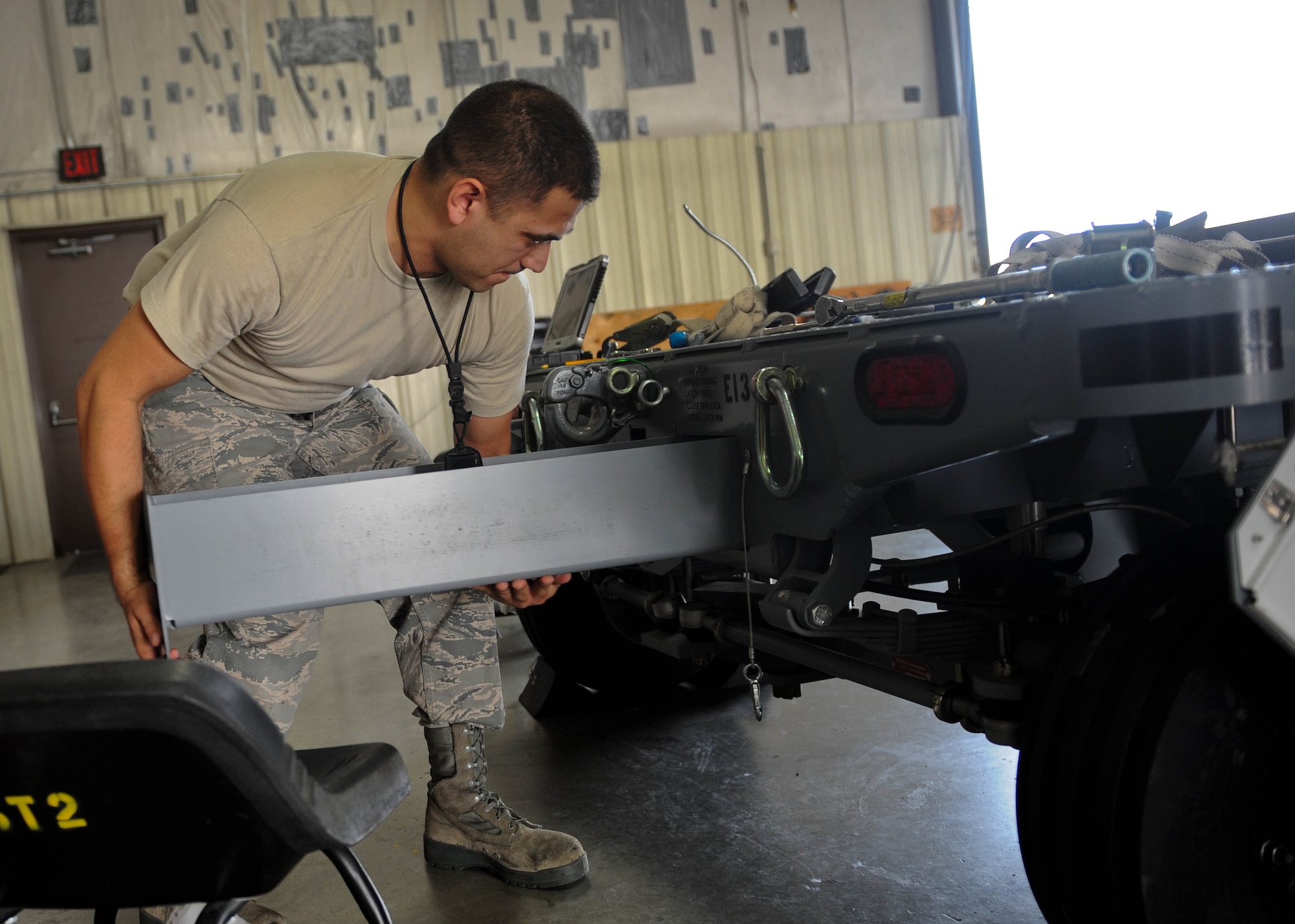 Senior Airman Richard Brooks, 28th Munitions Squadron equipment maintenance crew chief, performs scheduled maintenance on a munitions trailer on Ellsworth Air Force Base, S.D., Aug. 20, 2013. The shop performs preventative maintenance and periodic scheduled inspections on more than 160 trailers. (U.S. Air Force photo by Airman 1st Class Rebecca Imwalle)