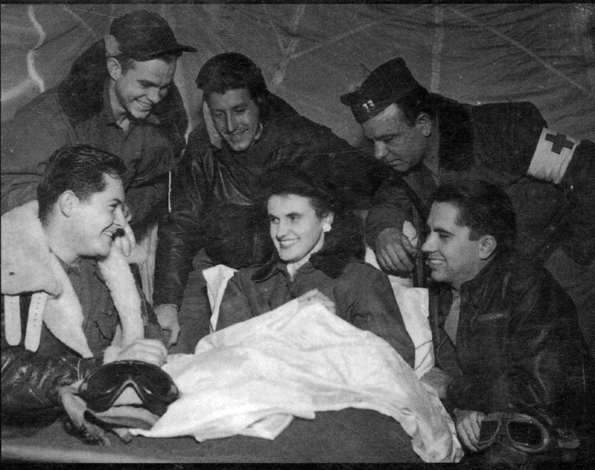Yvette is surrounded by a coterie of her 371st Fighter Group friends in her tent at an airfield in France, 1944.  Kneeling at left with a big smile is Captain Willis R. “Wally” Walling, a P-47 pilot from the group’s 404th Fighter Squadron. (From Annie Laurie Morgan’s book “Sunward I’ve Climbed”)