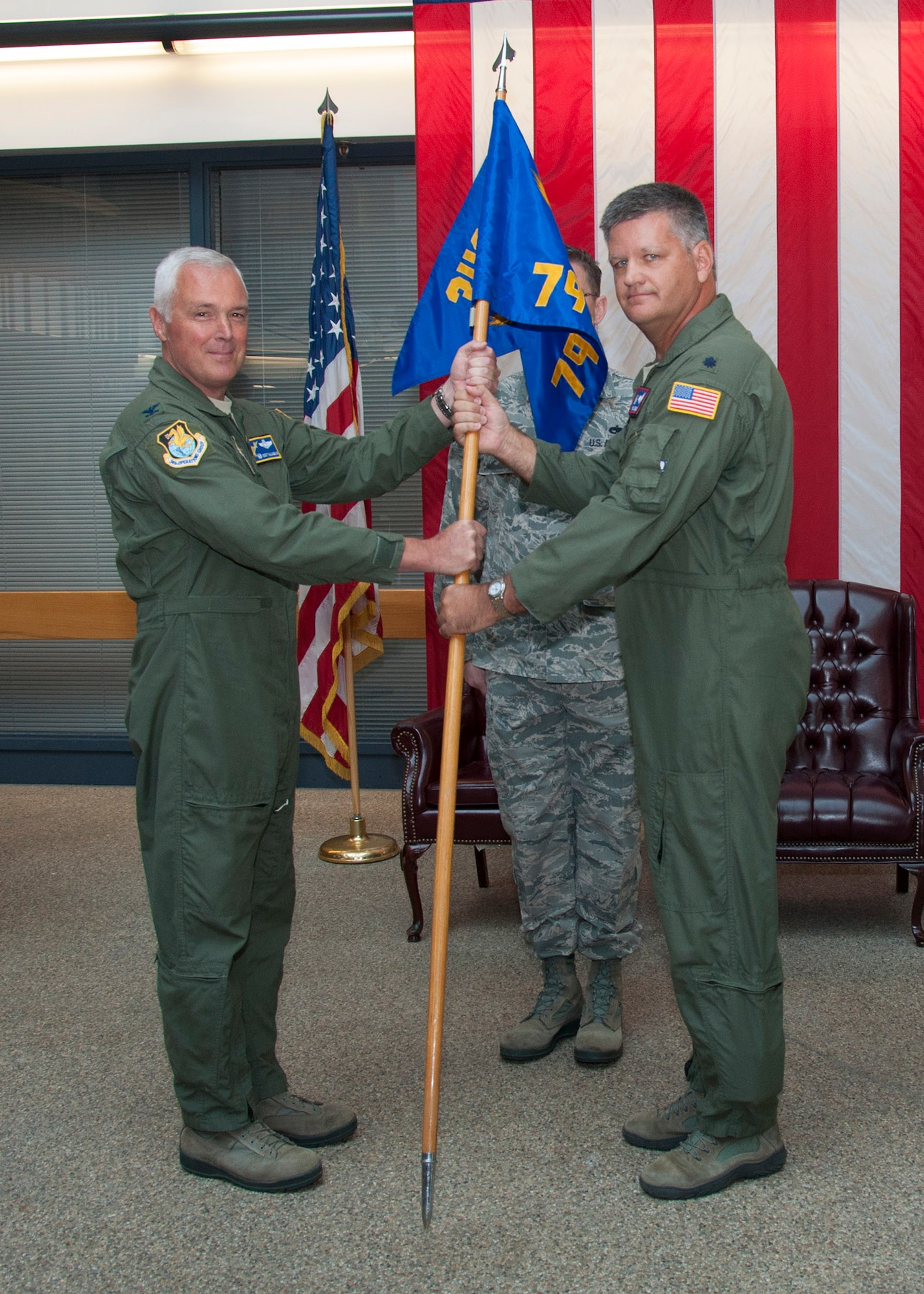 TRAVIS AIR FORCE BASE, Calif. -- Col. Scott McLaughlin, 349th Operations Group commander, accepts the 79th Air Refueling Squadron guidon from Lt. Col. Eric Jenkins, 79th ARS commander, during a change of command ceremony Aug. 24, 2013, at Travis Air Force Base, Calif. Jenkins relinquished command of the 79 ARS, the wing’s operational squadron responsible for flying the KC-10 Extender. (U.S. Air Force photo/Tech. Sgt. Rachel Martinez)