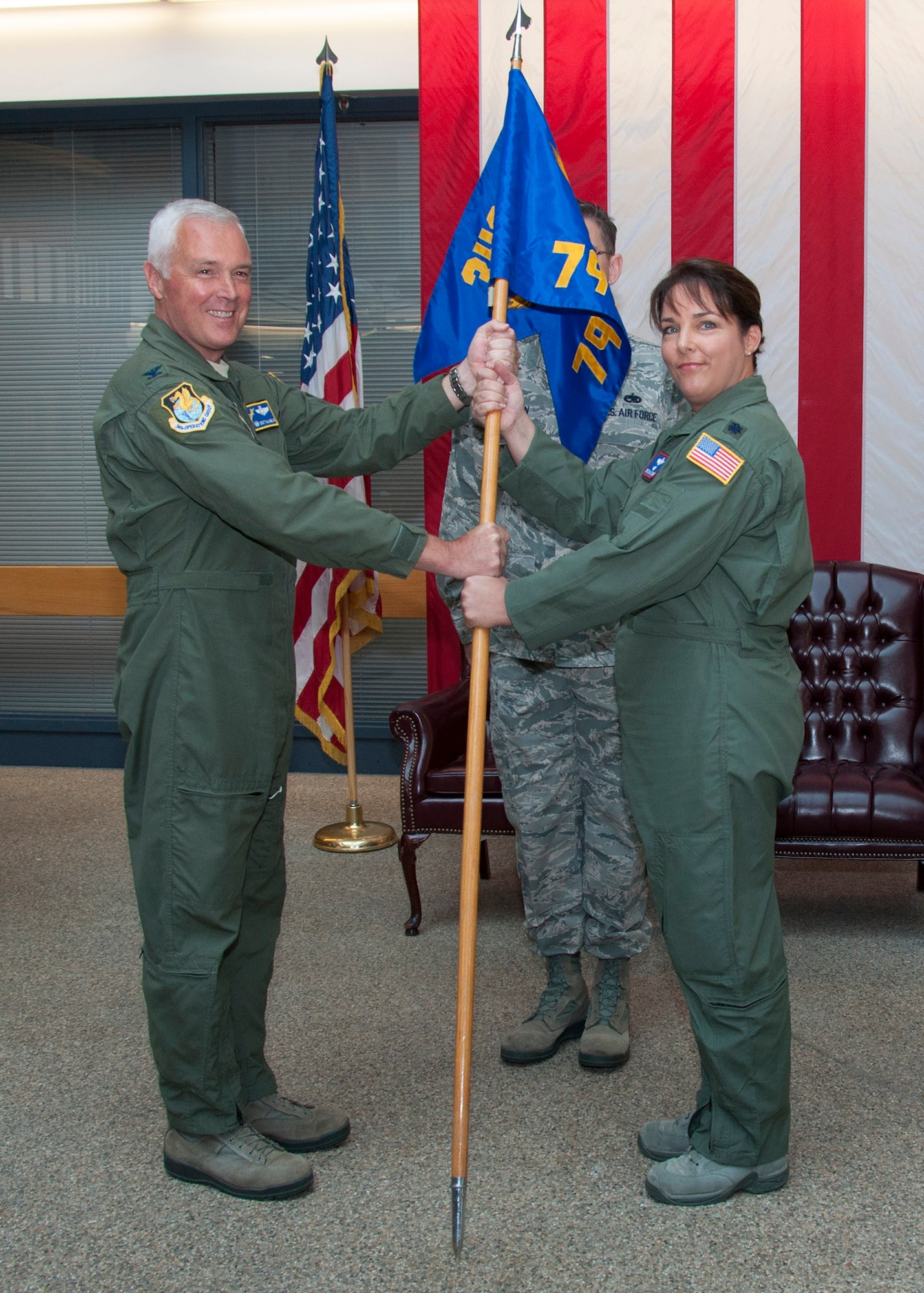 TRAVIS AIR FORCE BASE, Calif. -- Col. Scott McLaughlin, 349th Operations Group commander, passes the guidon to Lt. Col. Cristina Soares as she assumes command of the 79th Air Refueling Squadron during a ceremony Aug. 24, 2013, at Travis Air Force Base, Calif. (U.S. Air Force photo/Tech. Sgt. Rachel Martinez)