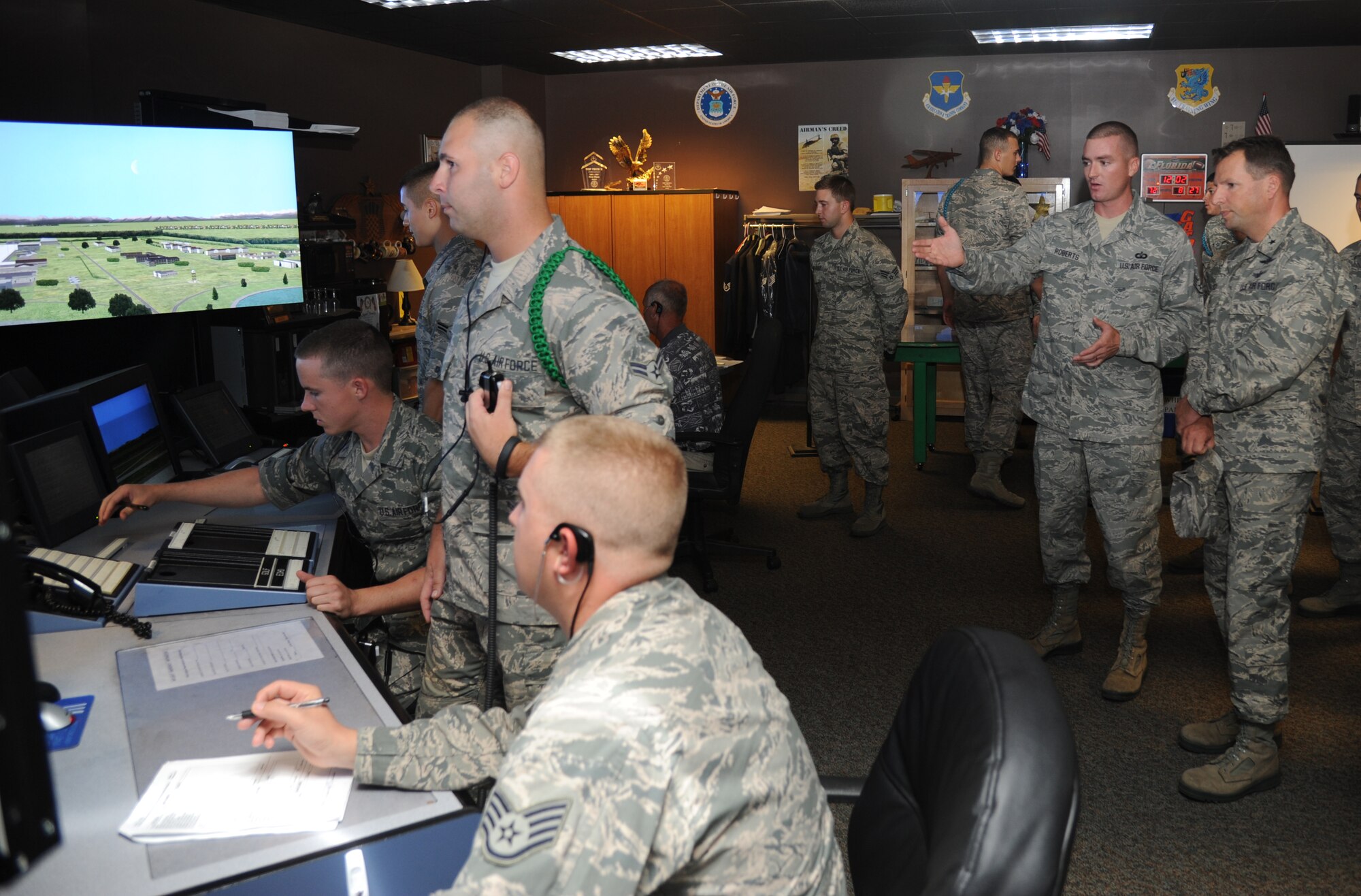 Staff Sgt. John Roberts, 334th Training Squadron, briefs Brig. Gen. Patrick Higby, 81st Training Wing commander, on the air traffic control tower simulator course during a two-day immersion tour of the 81st Training Group Aug. 26-27, 2013, at Cody Hall, Keesler Air Force Base, Miss. The purpose of the tour was to learn the integration of the group’s mission, operations and personnel. Higby will continue his tour with the 81st Medical Group, 81st Mission Support Group and Wing Staff Agencies over the next couple of weeks.  (U.S. Air Force photo by Kemberly Groue)