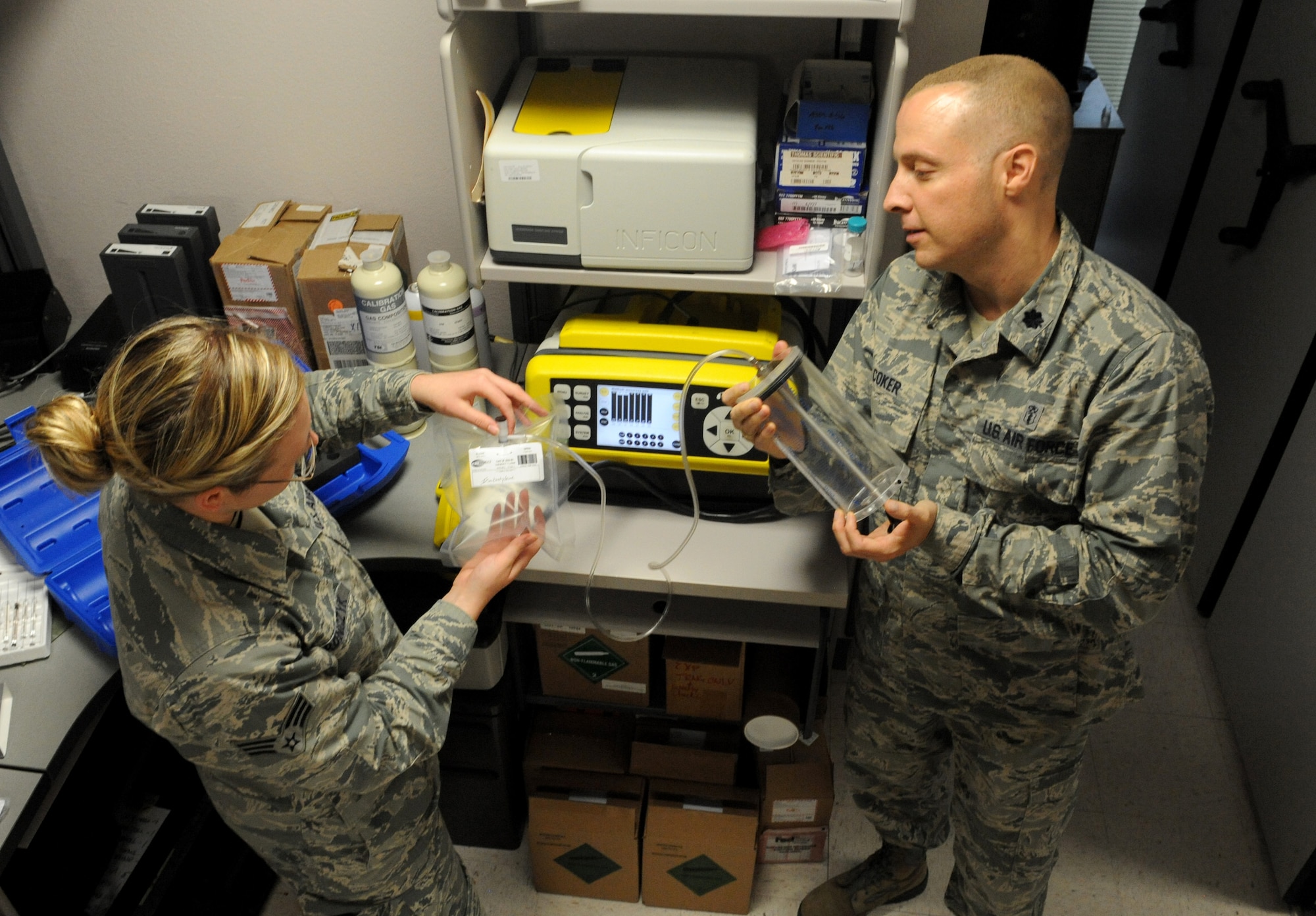 Senior Airmen Emily Yaronczyk, 375th Aerospace Medicine Squadron bioenvironmental engineering journeyman, shows Lt. Col. James Coker, 375th AMDS commander how to use the HAPSITE Chemical Identification System, which is a field-portable gas chromatograph/mass spectrometer.  The GC/MS is designed for on-scene detection, identification and quantification of toxic industrial chemicals and chemical warfare agents.  It is the benchmark for positive identification of organic chemicals with the highest degree of accuracy of any available analytical technique. With the HAPSITE Chemical Identification System, users get the confirmatory results within minutes that are necessary to make critical decisions affecting life, health, safety and the mission.  (U.S. Air Force photo/Staff Sgt. Maria Bowman)