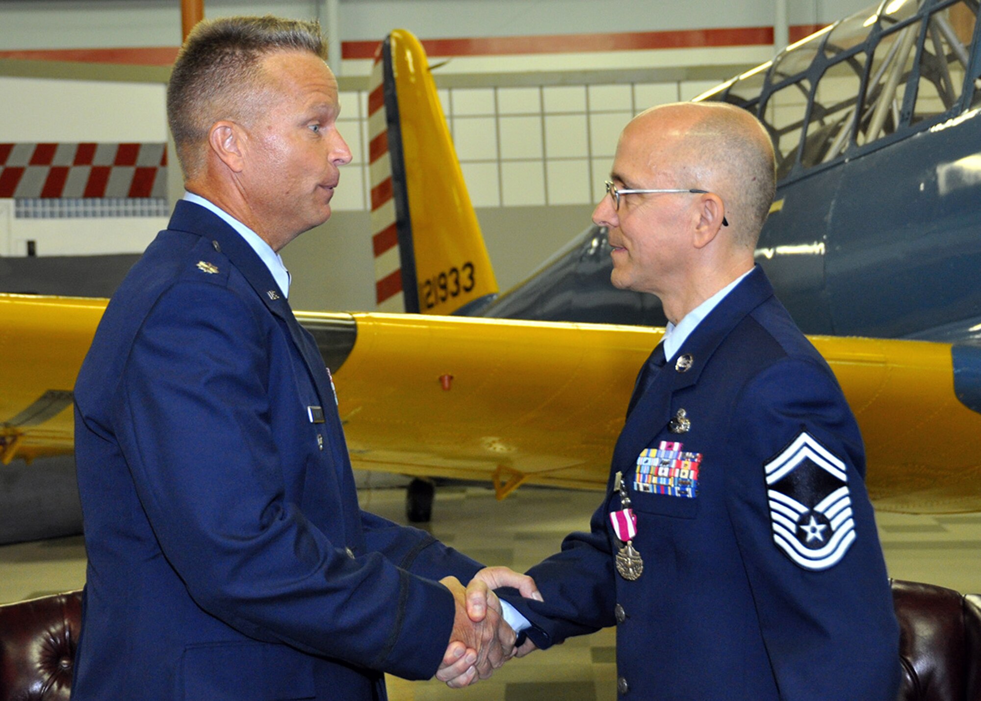 TRAVIS AIR FORCE BASE, Calif. -- Lt. Col. Roger Law, 349th maintenance group deputy commander, congratulates Senior Master Sgt. Kelly Norris at his retirement ceremony held at the Heritage Center, Travis Air Force Base, Calif. (U.S. Air Force photo / Senior Master Sgt. Robert Wade) 