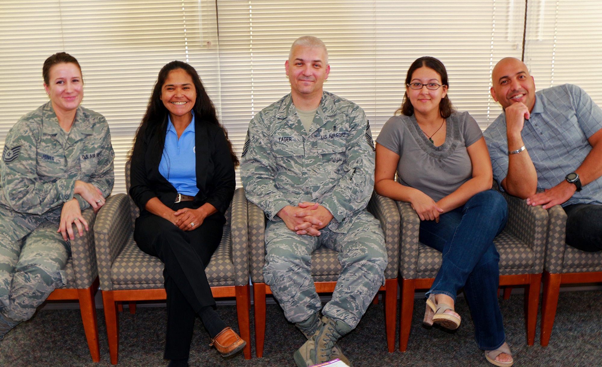 From left to right, Tech. Sgt. Elizabeth Jones, Senior Master Sgt. Emiliana Harris, Senior Master Sgt. Richard Yager, Tech Sgt. Sherlly Lange, and Master Sgt. Carlos Feliciano, all from the 446th Aerospace Medicine Squadron, smile for the camera in the waiting room of 446th AMDS Aug. 23. Jones, Harris, Yager, and Lange are all new to their air reserve technician positions, while Feliciano has been the command support staff noncommissioned officer in charge for the squadron since 2005. (U.S. Air Force Reserve photo by Senior Airman Madelyn McCullough)