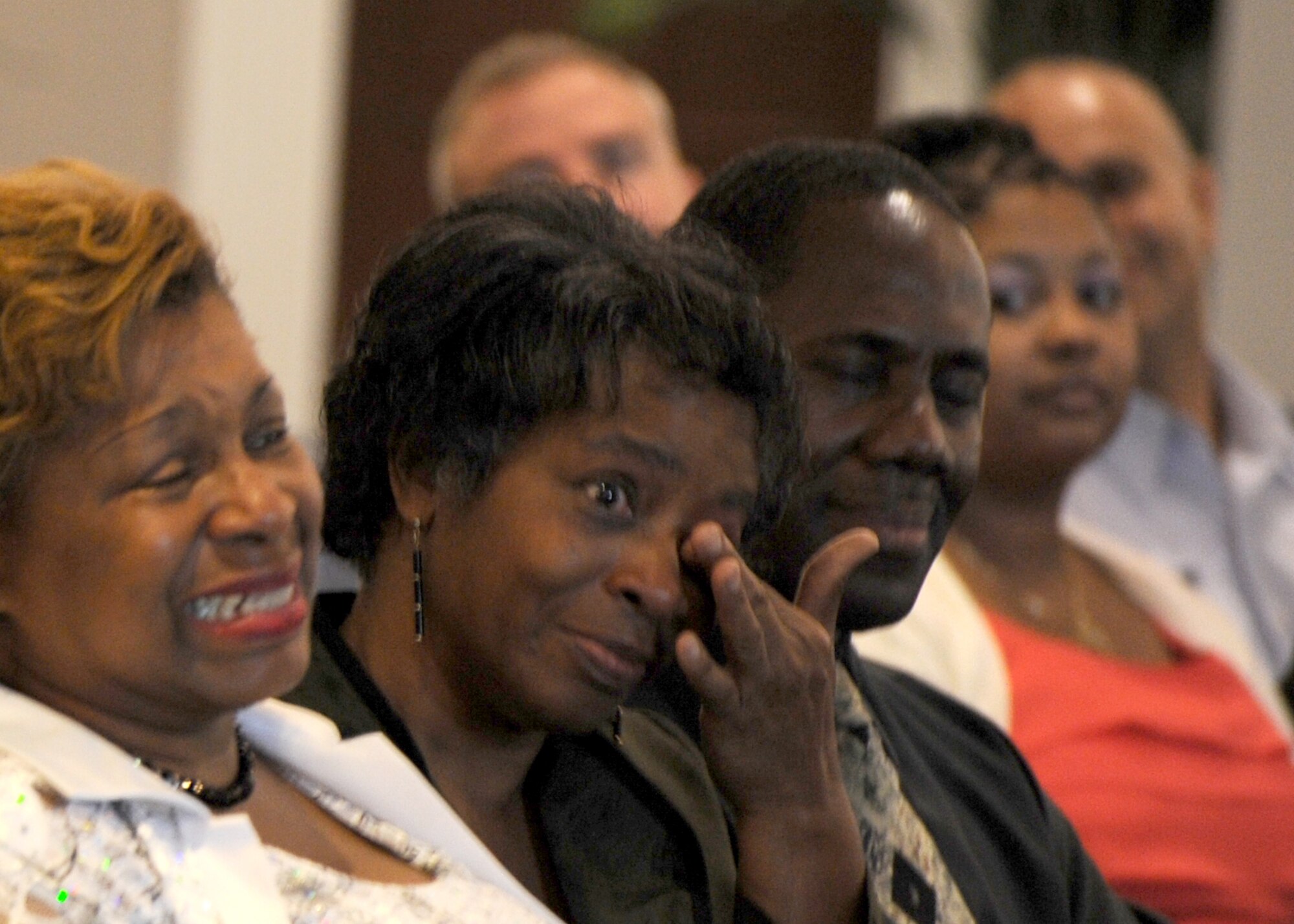Family members and friends shed tears during the the Air Force District of Washington bi-montly retirement ceremony Aug. 27, 2013, at The Club on Joint Base Anacostia-Bolling, D.C. Any Airman who serves in AFDW command can elect to retire during the ceremony. (U.S. Air Force photo by Tech. Sgt. Tammie Moore)